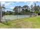 Community tennis court bordered by fencing and lush greenery at 505 Forestbrook Dr., Myrtle Beach, SC 29579