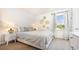 Cozy bedroom features a queen bed, bedside table with lamp, and a sunlit window with views at 512 Haven View Way, Murrells Inlet, SC 29576