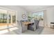 Bright dining room features a large window, sliding doors, and stylish gray dining chairs at 512 Haven View Way, Murrells Inlet, SC 29576