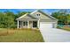 Charming single-story home with a manicured lawn, attached garage, and cozy front porch at 512 Haven View Way, Murrells Inlet, SC 29576