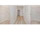 Bright hallway with wood flooring leading to bathroom, walk in closets on either side with metal racking at 512 Haven View Way, Murrells Inlet, SC 29576