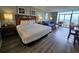 Relaxing hotel bedroom with queen bed, ocean view balcony, and seating area at 5300 N Ocean Blvd. # 310, Myrtle Beach, SC 29577