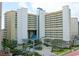 Expansive exterior view of a hotel featuring multiple floors and balconies, with palm trees and parking area at 5300 N Ocean Blvd. # 310, Myrtle Beach, SC 29577