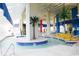 Indoor lazy river adorned with palm trees and yellow floats, creating a tropical water experience at 5300 N Ocean Blvd. # 310, Myrtle Beach, SC 29577