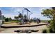 Vibrant community playground offering slides and climbing structures with playful alligator statue in a sandy area at 5300 N Ocean Blvd. # 310, Myrtle Beach, SC 29577