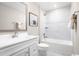 Well-lit bathroom features a white vanity, framed mirror, and a shower-tub combination with white tile at 532 Ryegrass Way # 0029B, Murrells Inlet, SC 29576