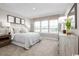 Comfortable bedroom with a large window offering natural light and a view of a peaceful pond at 532 Ryegrass Way # 0029B, Murrells Inlet, SC 29576