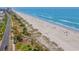 Stunning aerial view of a beach featuring a charming wooden walkway and coastal vegetation at 5601 N Ocean Blvd. # E-304, Myrtle Beach, SC 29577