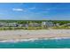 Oceanfront condominium complex on white sandy beach with mature trees and lush landscaping at 5601 N Ocean Blvd. # E-304, Myrtle Beach, SC 29577