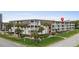 Low-rise condominium complex with landscaped grounds, mature trees, and white exterior at 5601 N Ocean Blvd. # E-304, Myrtle Beach, SC 29577