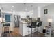 Bright kitchen features white cabinetry, stainless steel appliances, granite counters and breakfast bar with modern lighting at 5601 N Ocean Blvd. # E-304, Myrtle Beach, SC 29577
