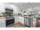 This kitchen has granite countertops, stainless appliances, sleek backsplash and light-colored cabinets at 5601 N Ocean Blvd. # E-304, Myrtle Beach, SC 29577