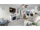 Comfortable living room and adjacent dining area with fireplace and mounted television at 5601 N Ocean Blvd. # E-304, Myrtle Beach, SC 29577
