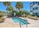 A tranquil community pool with turquoise water and palm trees under a bright blue sky at 5601 N Ocean Blvd. # E-304, Myrtle Beach, SC 29577