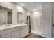 Bathroom featuring a double sink vanity, sleek lighting and walk-in shower at 572 Woodland Farms Circle, Aynor, SC 29511