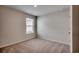 This bedroom boasts neutral walls, plush carpet, and a window at 572 Woodland Farms Circle, Aynor, SC 29511