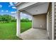 Covered patio with large column and views of spacious green backyard at 572 Woodland Farms Circle, Aynor, SC 29511