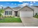 Single-story house with vinyl siding, a two-car garage, and a well-manicured lawn at 572 Woodland Farms Circle, Aynor, SC 29511
