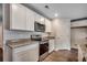 Well-equipped kitchen featuring granite countertops, stainless steel appliances, and white cabinets at 572 Woodland Farms Circle, Aynor, SC 29511
