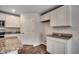 Well-lit kitchen boasts granite countertops, ample white cabinetry, and stainless steel appliances at 572 Woodland Farms Circle, Aynor, SC 29511