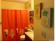A playful bathroom has fun, beach-themed decorations and a shower with a vibrant curtain at 5905 S Kings Hwy. # 314-B, Myrtle Beach, SC 29575