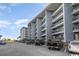 Exterior condominium view showing ample parking near the beach and balcony views from residential units at 5905 S Kings Hwy. # 314-B, Myrtle Beach, SC 29575