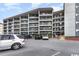 Exterior view showing parking for the condominium with multiple floors and great balcony views at 5905 S Kings Hwy. # 314-B, Myrtle Beach, SC 29575