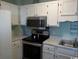 This kitchen features stainless steel appliances, white cabinets, and patterned countertops at 5905 S Kings Hwy. # 314-B, Myrtle Beach, SC 29575