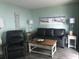 A nicely decorated living room features a sofa, recliner, beach-themed artwork, and side tables at 5905 S Kings Hwy. # 314-B, Myrtle Beach, SC 29575
