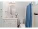 Bright bathroom featuring a round mirror, vanity, and a shower with a blue curtain at 6001-1872 S Kings Hwy., Myrtle Beach, SC 29575