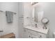 Bright bathroom with white vanity, oval mirror, and built-in storage at 6001-1872 S Kings Hwy., Myrtle Beach, SC 29575