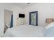 Bedroom with a TV, dresser, and door to the outside with blue trim at 6001-1872 S Kings Hwy., Myrtle Beach, SC 29575