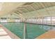 Indoor swimming pool with a clear roof, handrails, and a brick patterned floor at 6001-1872 S Kings Hwy., Myrtle Beach, SC 29575