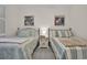 Charming bedroom with two twin beds, beach-themed decor, and inviting atmosphere at 601 Hillside Dr. N # 1405, North Myrtle Beach, SC 29582