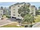 Condominium featuring a parking garage, lush landscaping, and charming design at 601 Hillside Dr. N # 1405, North Myrtle Beach, SC 29582