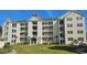 Beautiful condominium featuring balconies, lush landscaping, and a charming building design at 601 Hillside Dr. N # 1405, North Myrtle Beach, SC 29582