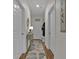 Hallway with three doors, wood floors, area rug, table, and coat rack at 601 Hillside Dr. N # 1405, North Myrtle Beach, SC 29582