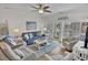 Bright living room with stylish furniture, a ceiling fan, and balcony access, perfect for relaxation at 601 Hillside Dr. N # 1405, North Myrtle Beach, SC 29582