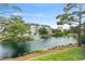Scenic view of a tranquil pond with fountain, surrounded by mature trees and condo buildings at 601 Hillside Dr. N # 1405, North Myrtle Beach, SC 29582