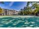 View of a well-maintained tennis court surrounded by lush landscaping and condominium buildings at 601 Hillside Dr. N # 1405, North Myrtle Beach, SC 29582