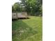 Wooden back deck with stairs leading to a spacious backyard and chain link fence at 615 Burcale Road Circle, Myrtle Beach, SC 29579