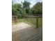 A wooden back deck featuring a wooden railing and a view of the green backyard at 615 Burcale Road Circle, Myrtle Beach, SC 29579