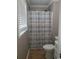 Functional bathroom features toilet, shower with curtain and window, and storage vanity at 615 Burcale Road Circle, Myrtle Beach, SC 29579