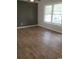 Cozy bedroom with wood flooring, large window, and neutral paint, creating a warm, inviting atmosphere at 615 Burcale Road Circle, Myrtle Beach, SC 29579