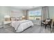 This bedroom boasts a comfortable queen bed, chair and natural light from the window at 619 Culmen Ct., Myrtle Beach, SC 29588