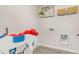 Laundry room with overhead shelving, modern flooring, and whimsical decorations at 619 Culmen Ct., Myrtle Beach, SC 29588