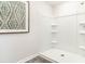 Clean and modern shower with built-in shelving and pristine white finishes at 619 Culmen Ct., Myrtle Beach, SC 29588