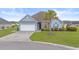 Charming one-story home features blue siding, a well-manicured lawn, and a mature palm tree at 713 Garland Ct., Myrtle Beach, SC 29588