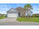 Charming one-story home features blue siding, a well-manicured lawn, and a mature palm tree at 713 Garland Ct., Myrtle Beach, SC 29588