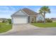 Charming single-story home features light blue siding, an attached garage, and landscaped yard at 713 Garland Ct., Myrtle Beach, SC 29588